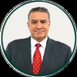 Professional headshot of a middle-aged man in a dark suit and red tie against a white background
